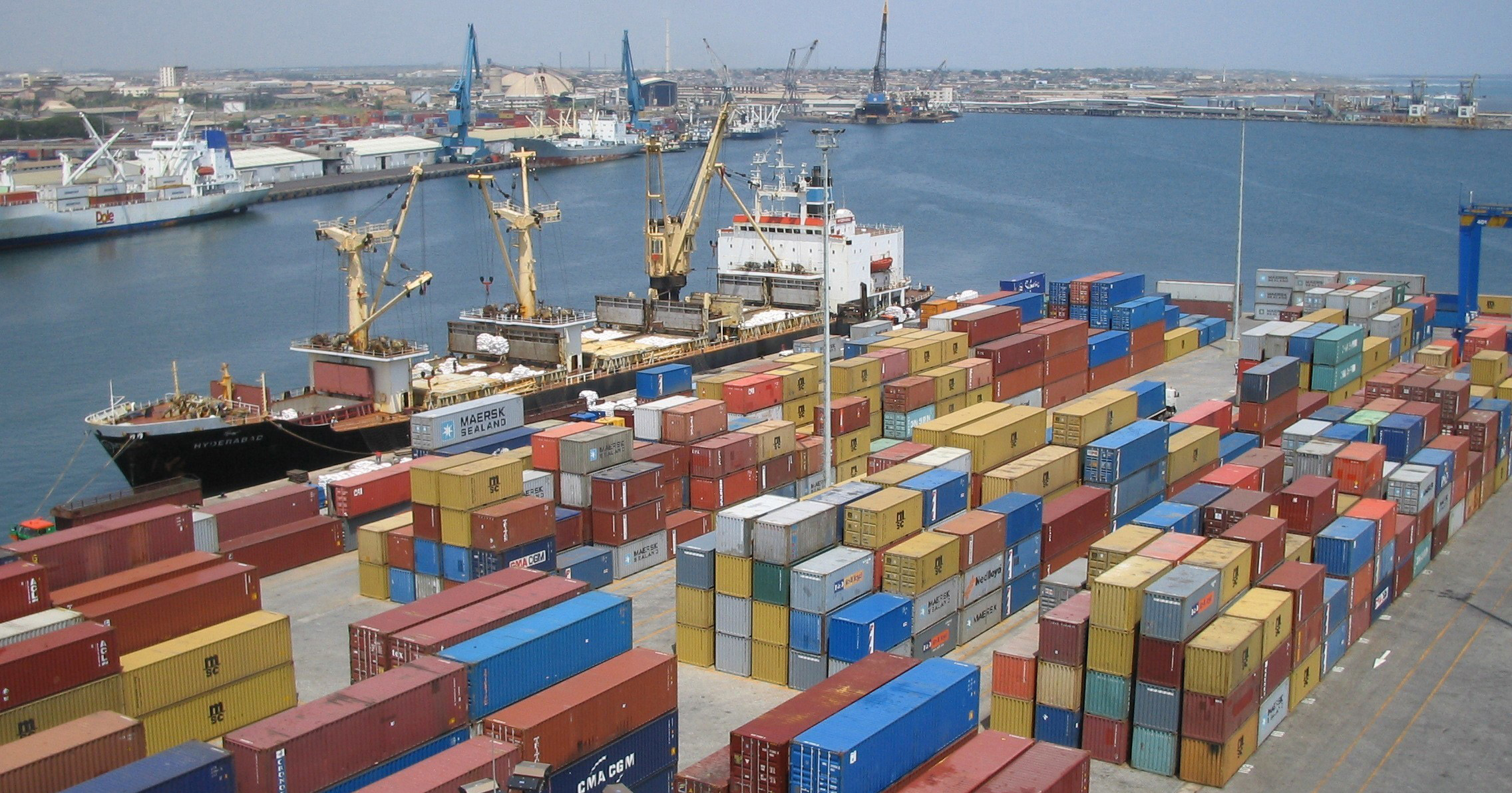 ship at seashore and many containers