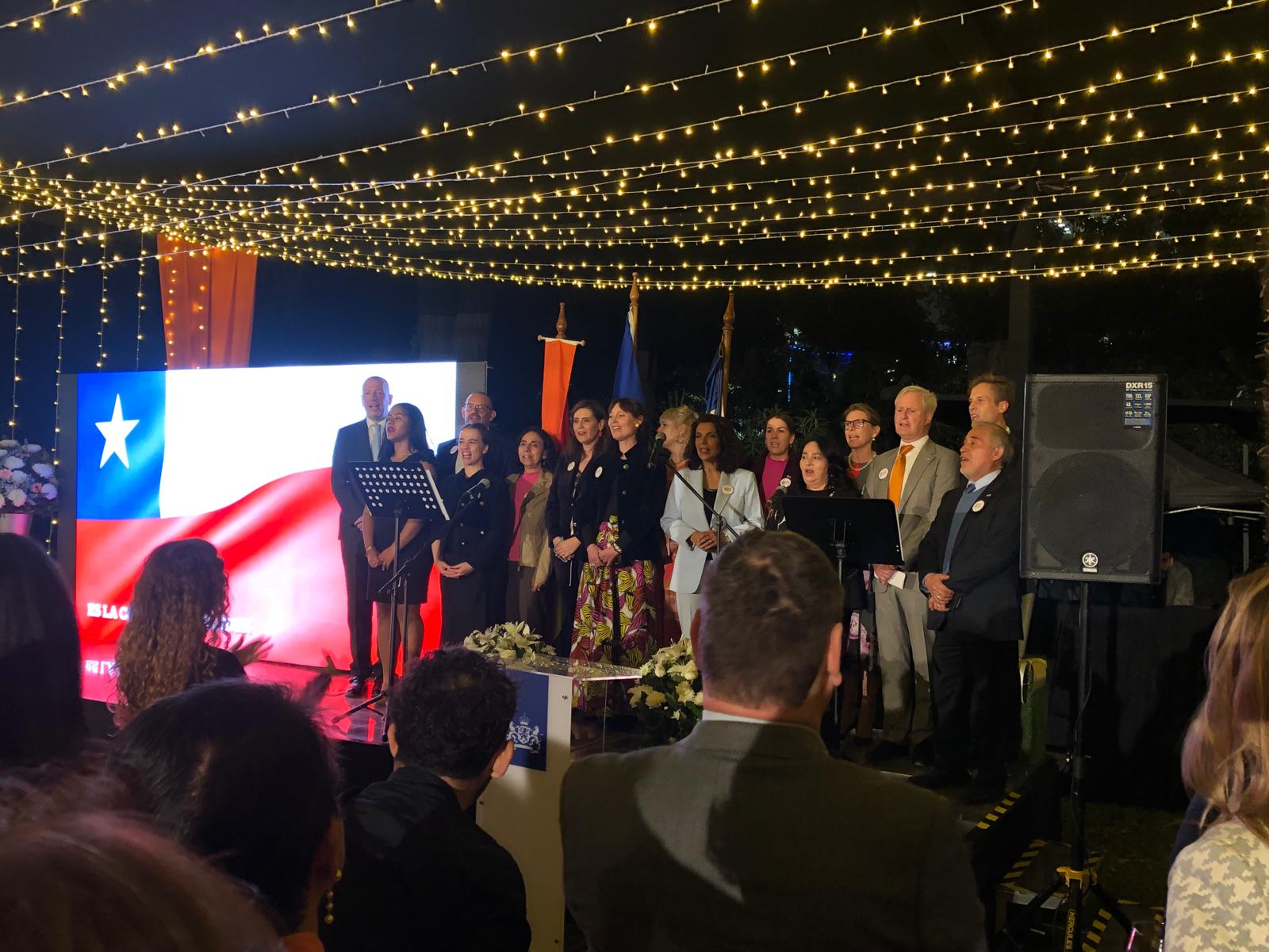 The team of the embassy singing the national anthems.