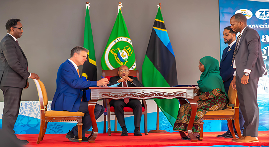 President Hussein Mwinyi witnesses the signing of the construction of the Mpigaduri passenger port between the founder of the ZF Devco company, Matthew VanderBirgh (left) and the PS of the Ministry of Construction, Communication and Transport, Khadija Khamis Rajab at the State House, Zanzibar