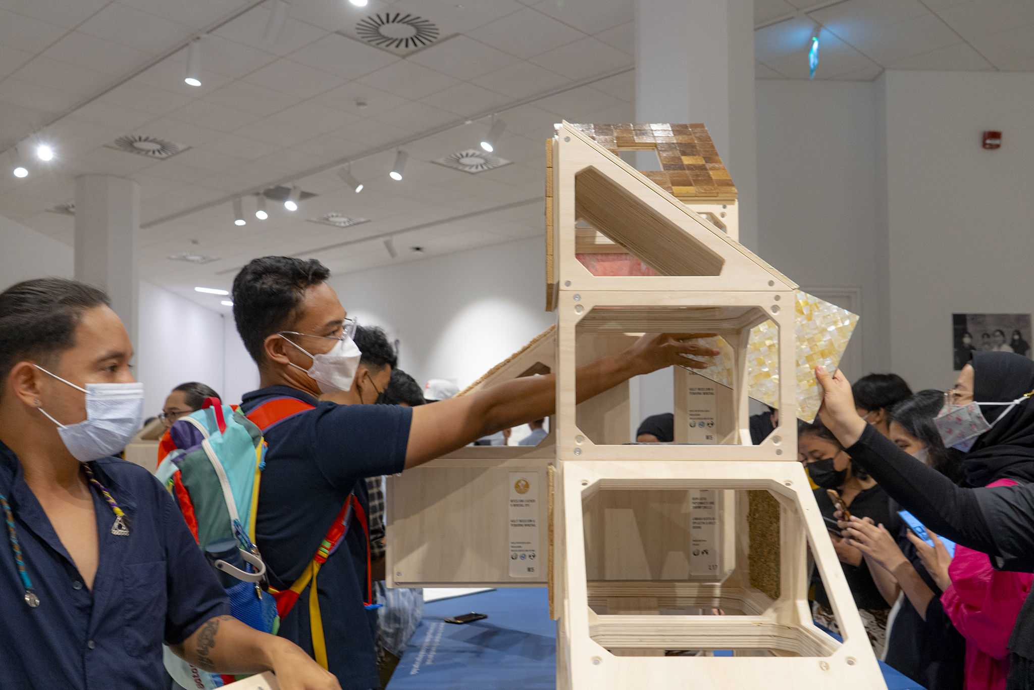 Visitors interact during the opening of Building with Nature Exhibition by Company New Heroes