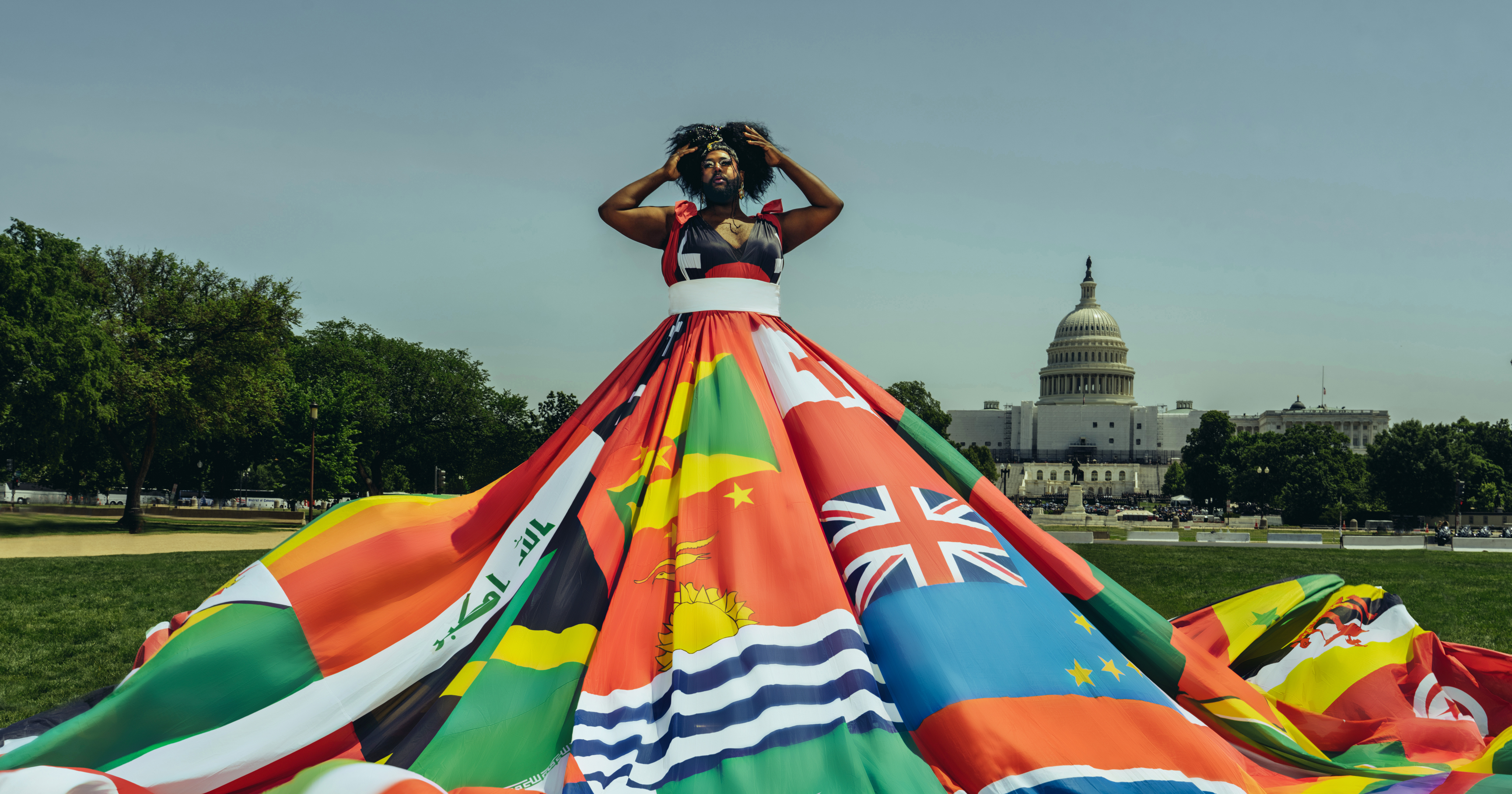 Amsterdam Rainbow Dress made from flags of 68 countries where being LGBTIQ+ is punishable by law- worn by LGBTIQ+ activist Vagenesis