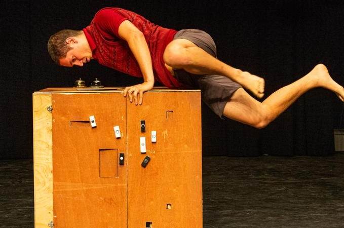 The actor playing Hermit balancing on a box