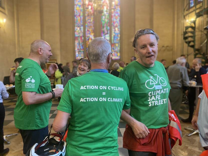 Old men in green shirts cycling